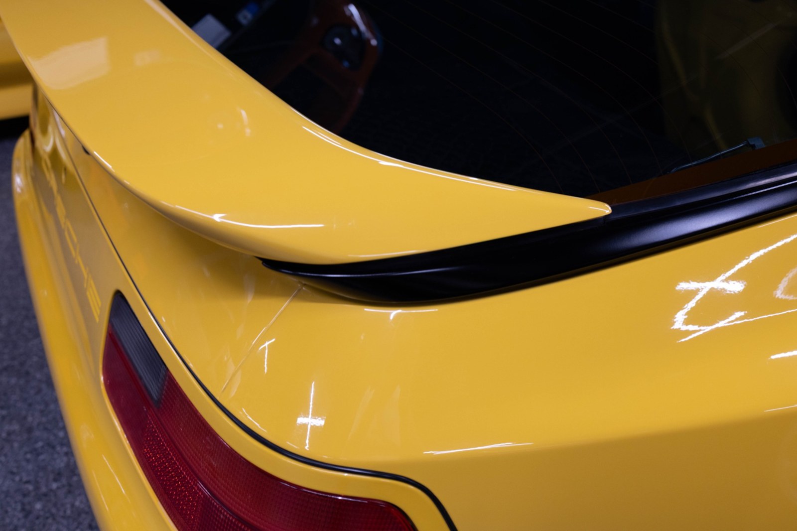 Porsche 968 rear spoiler and hatch detail in Speed Yellow